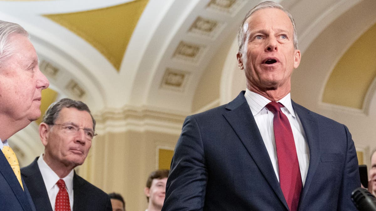 Senate Majority Leader Sen. John Thune of South Dakota, right, speaks to reporters, Feb. 11, 2025, after a Senate policy luncheon on Capitol Hill.