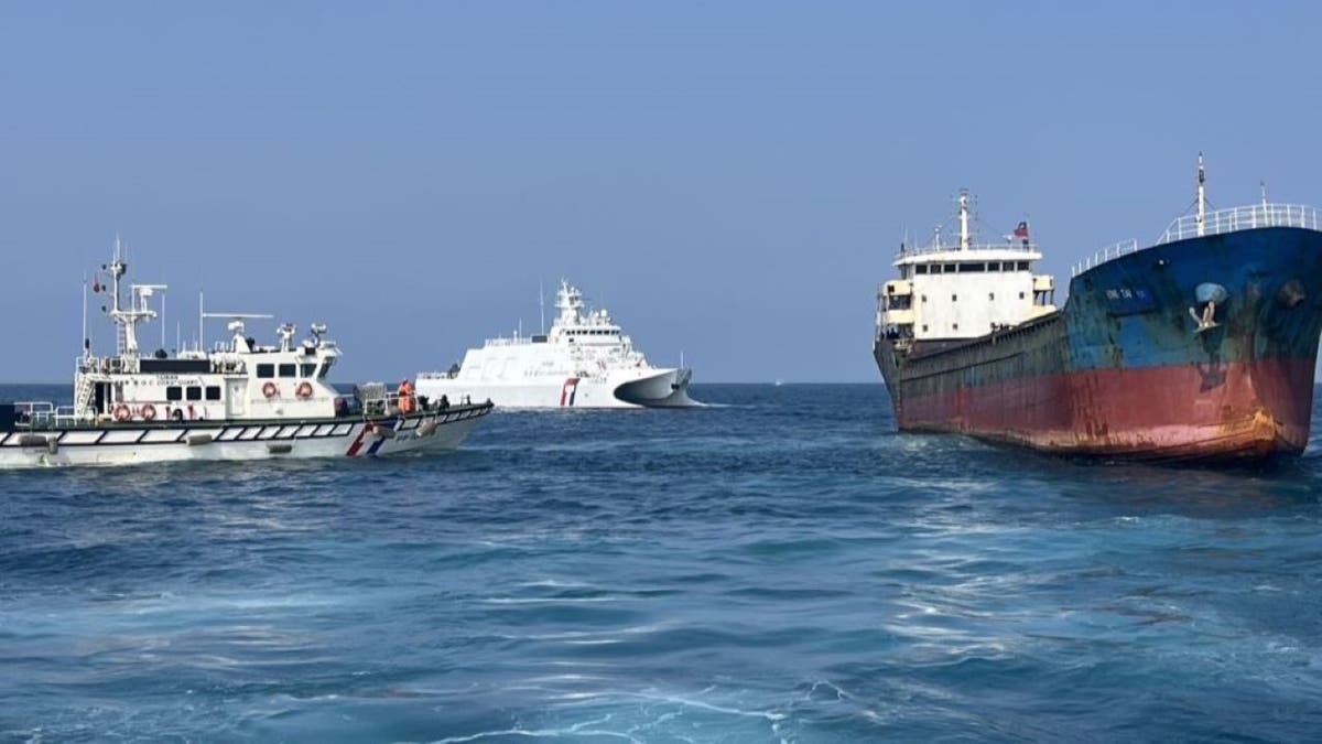 Two Taiwan Coast Guard personnel board a Togo-flagged cargo ship to conduct inspection on Feb. 25, 2025.