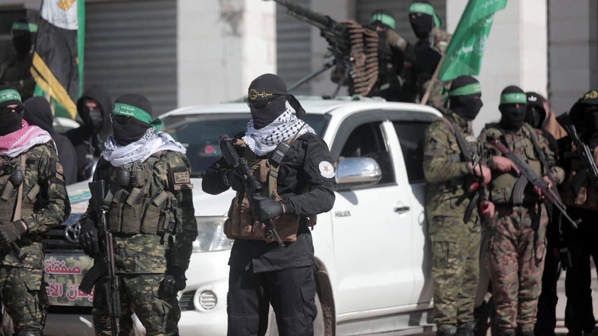 Members of the Hamas terror group gather in Gaza in preparation for the release of four female hostages as part of the ceasefire deal with Israel.