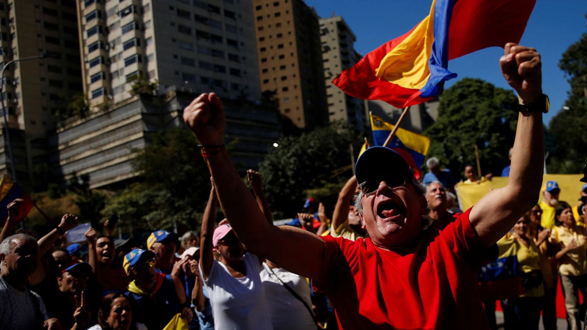 A supporter of Venezuela's opposition holds his arms up and shouts with fellow supporters ahead of President Nicolas Maduro's inauguration.