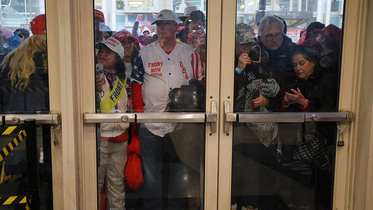 Supporters wait to enter the venue ahead of a U.S. President-elect Donald Trump rally