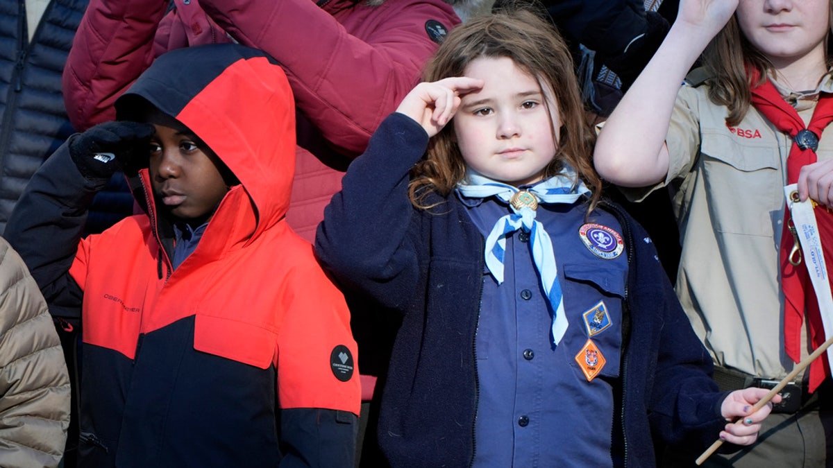 girl salutes outside Carter funeral