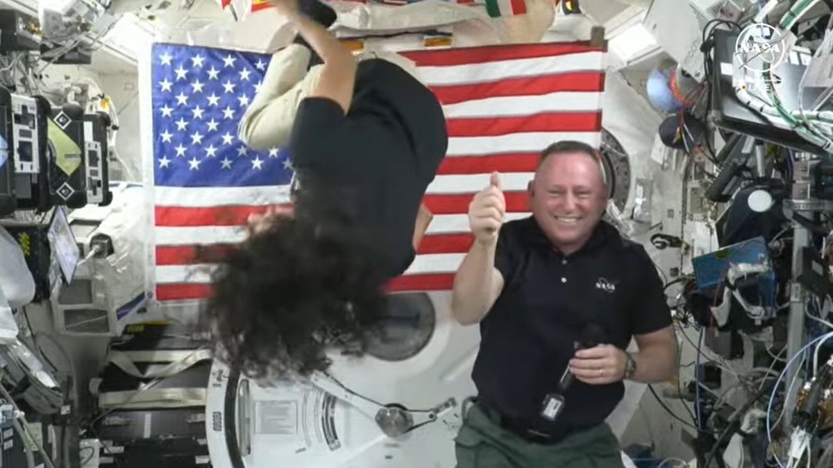 Astronaut Suni Williams does a backflip as Butch Wilmore gives a thumbs-up while in space.