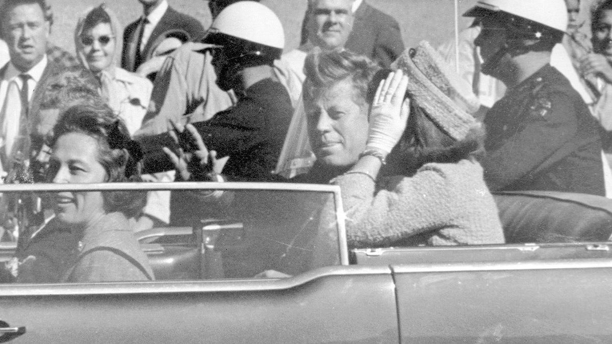 President John F. Kennedy waves