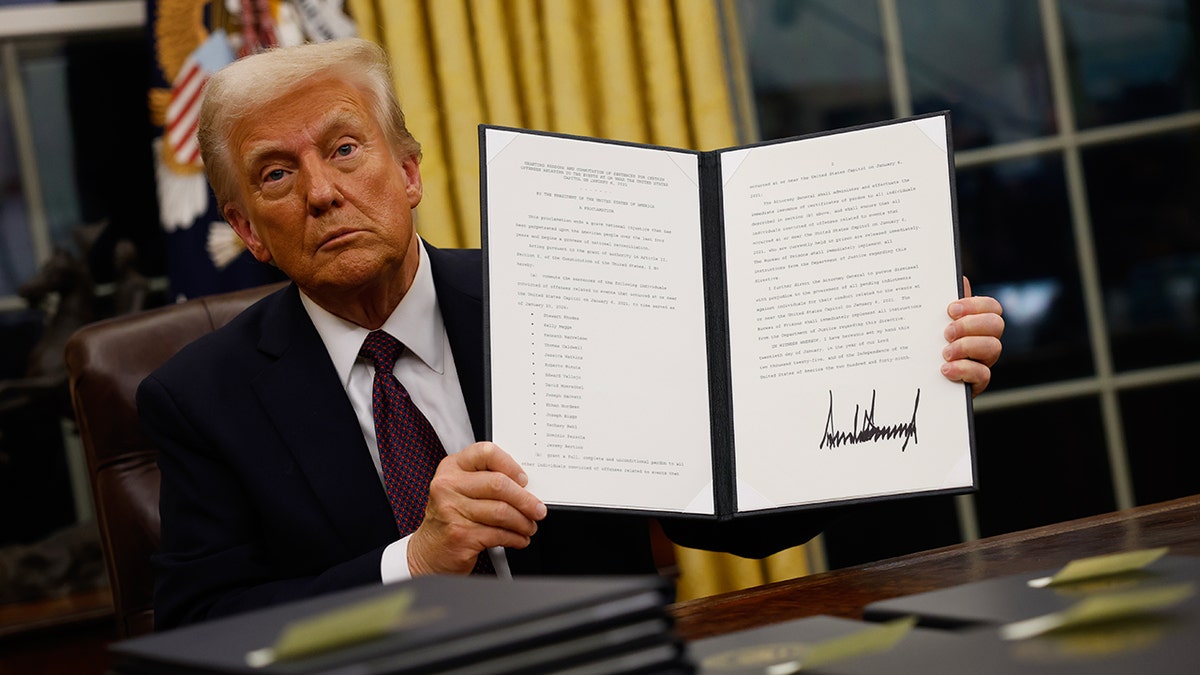 President Donald Trump signs executive orders in the Oval Office in Washington DC 