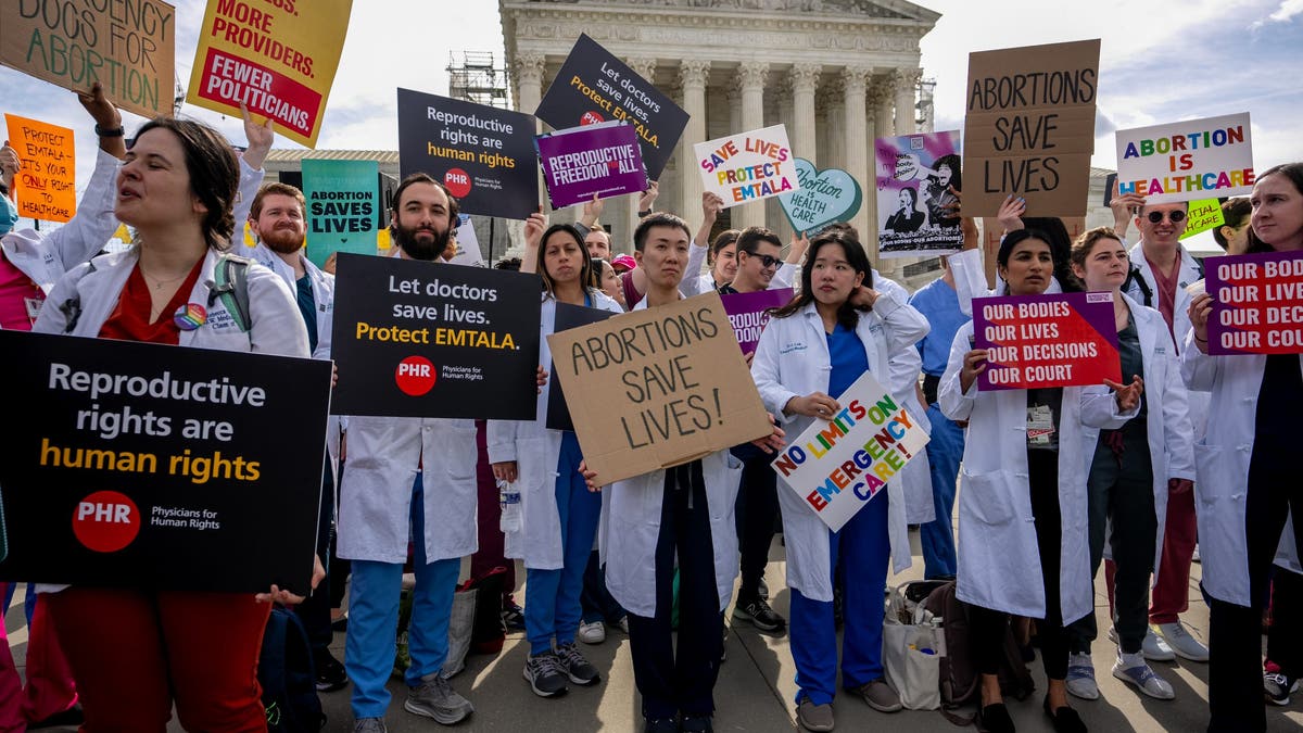 Doctors join abortion rights supporters at a rally outside the Supreme Court