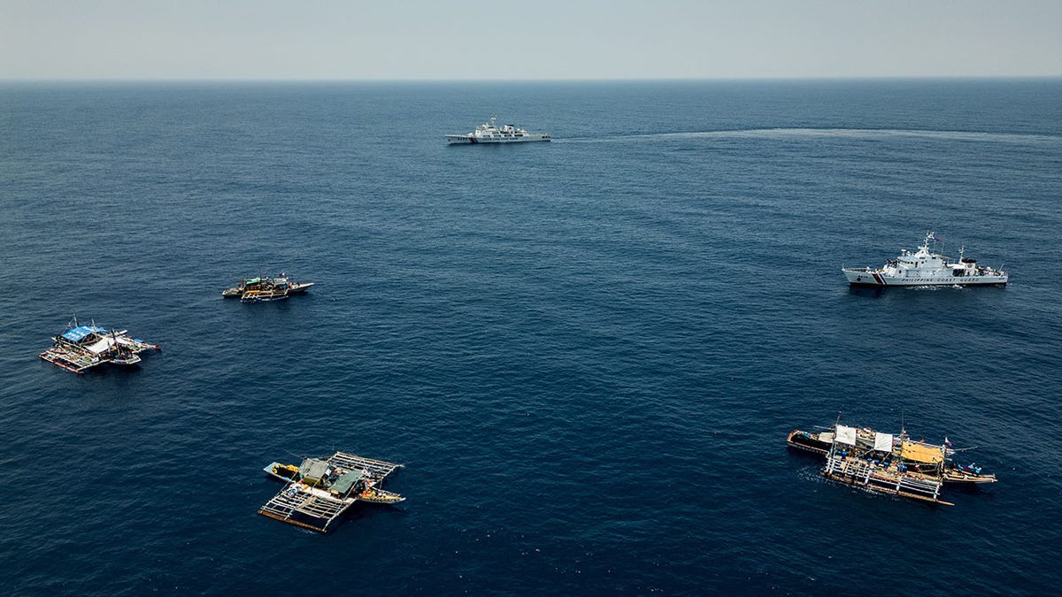 A Chinese Coast Guard ship is seen closely shadowing the convoy of Filipino fishing boats and a Philippine Coast Guard ship, on May 16, 2024.