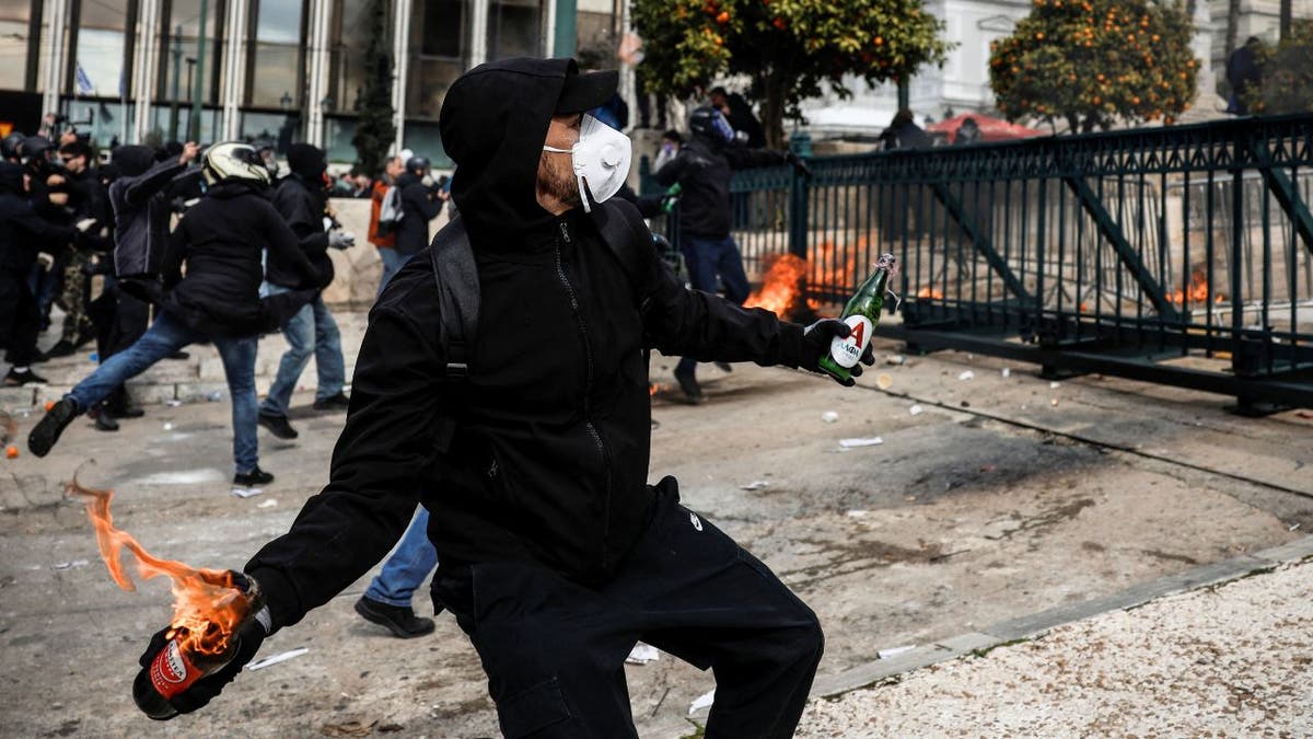 Protesters clash with police in front of the Greek parliament