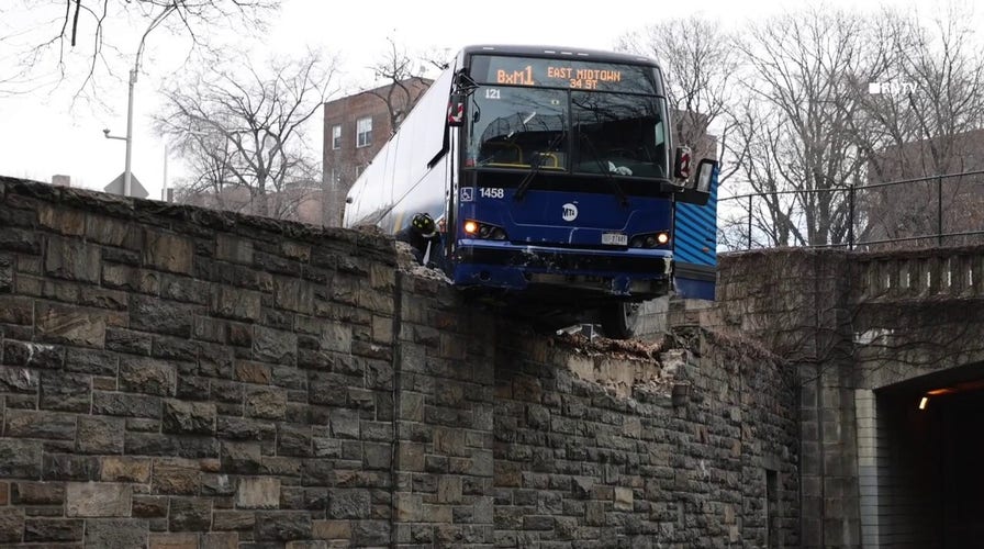 NYC MTA bus hangs precariously off overpass following collision