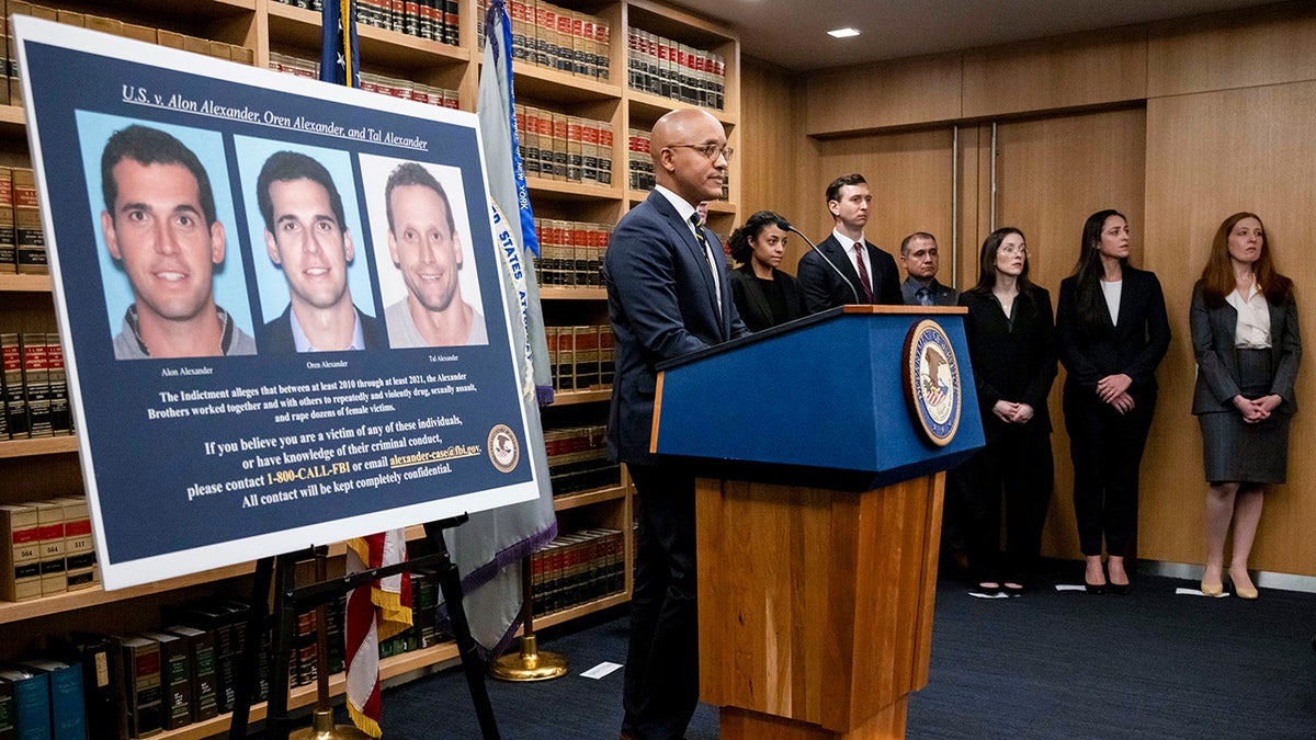 A display showing images of Alon, Oren, and Tal Alexander prior to a news conference in New York