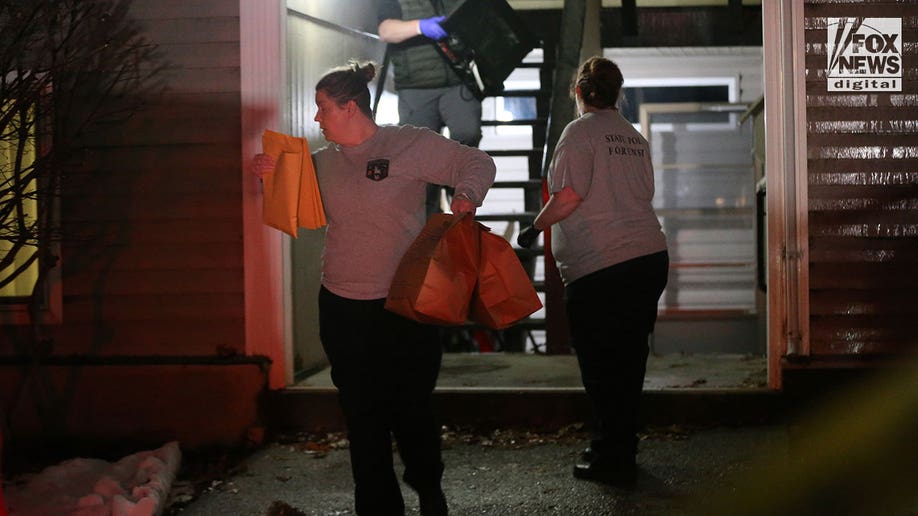 Investigators carry boxes out of Kohberger's Pullman apartment