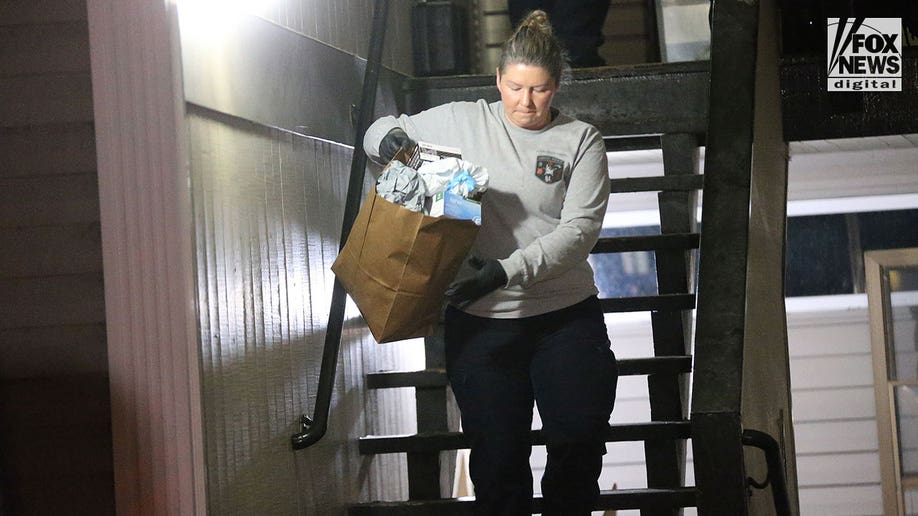 Investigators carry boxes out of Kohberger's Pullman apartment