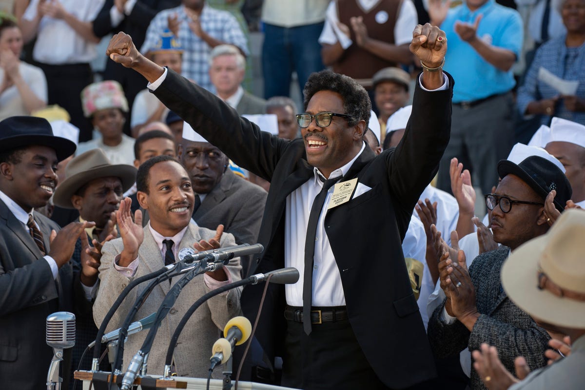 Colman Domingo as Bayard Rustin standing on a podium in front of a huge crowd