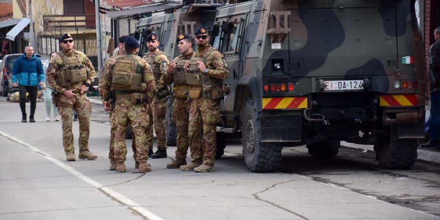 Soldiers of the NATO-led Kosovo Force patrol near a road barricade set up in the city of Mitrovica, Kosovo, on Dec. 29, 2022.