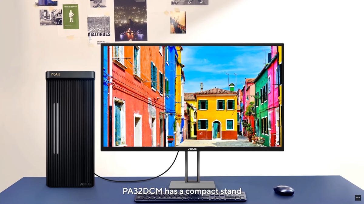 The PC32DCM display on a table next to an Asus compact workstation PC.