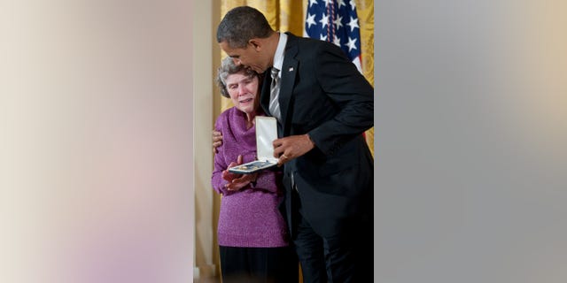 WASHINGTON, DC - FEBRUARY 15: President Barack Obama presents Sharing and Caring Hands co-founder Mary Jo Copeland with the 2012 Presidential Citizens Medal at the White House on February 15, 2013 in Washington, DC. (Photo by Leigh Vogel/WireImage)