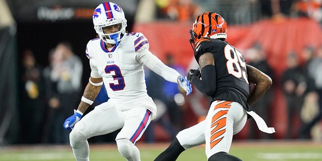 Cincinnati Bengals wide receiver Tee Higgins (85) runs near Buffalo Bills safety Damar Hamlin (3) during the first half of an NFL football game, Monday, Jan. 2, 2023, in Cincinnati. Hamlin was injured on the play. 