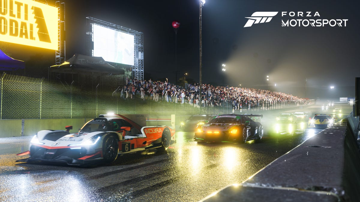 Racing cars preparing to take off in a Forza Motorsport trailer.