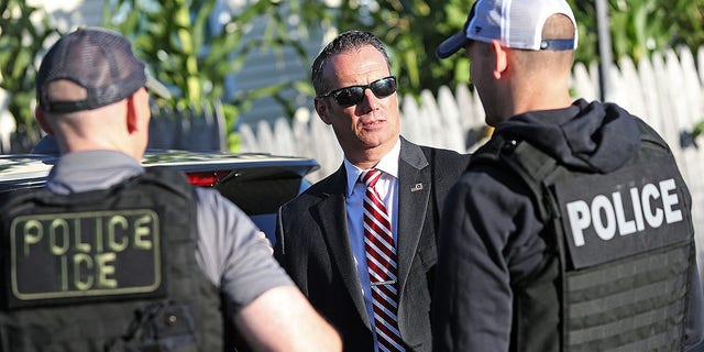 Todd Lyons, Immigration and Customs Enforcement Acting Field Office Director talks with his agents after they made three arrests on September 25, 2019 in Revere, Massachusetts.  