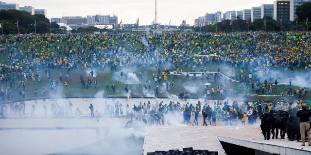 Supporters of Brazil's former President Jair Bolsonaro demonstrate against President Luiz Inacio Lula da Silva as security forces operate, outside Brazil’s National Congress in Brasilia, Brazil, January 8, 2023. REUTERS/Adriano Machado/File Photo