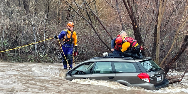 California rescue team saves man who got vehicle trapped in floodwaters.