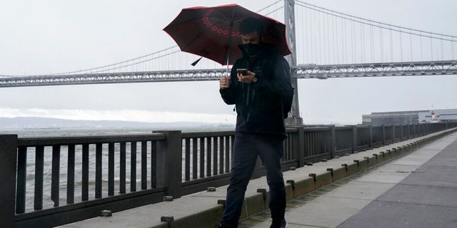 A person walks on The Embarcadero in San Francisco, Wednesday, Jan. 4, 2023.