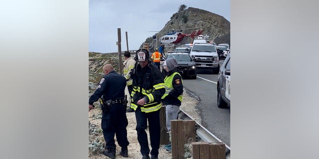 In this image from video provided by San Mateo County Sheriff's Office, emergency personnel respond after a Tesla plunged off a Northern California cliff along the Pacific Coast Highway, Monday, Jan. 2, 2023, near an area known as Devil's Slide, leaving four people in critical condition, a fire official said.