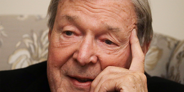 Cardinal George Pell answers a journalist's question during an interview with inside his residence near the Vatican in Rome, Nov. 30, 2020.