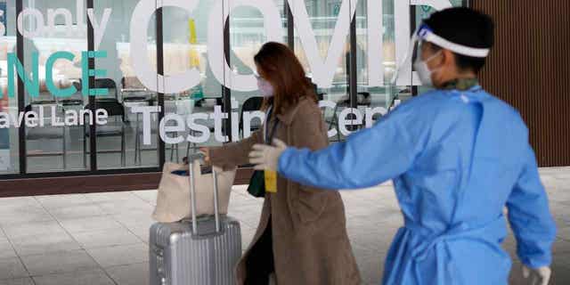 A woman arriving from China enters a COVID-19 testing center at an airport in Incheon, South Korea, on Jan. 5, 2023. China suspended visas for South Koreans to come to the country for tourism or business in alleged retaliation for COVID-19 testing requirements on Chinese travelers. 