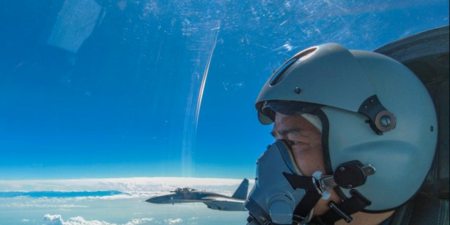 In this photo released by Xinhua News Agency, an air force pilot from the Eastern Theater Command of the Chinese People's Liberation Army (PLA) looks as they conduct a joint combat training exercises around the Taiwan Island on Sunday, Aug. 7, 2022. 