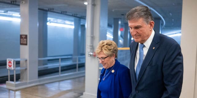 Sen. Joe Manchin, D-W.V., walks with his wife in the U.S. Capitol building. 