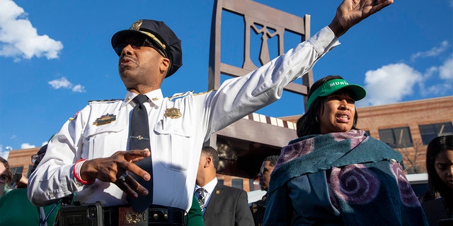 D.C. Police Chief Robert J. Contee III and Mayor Muriel Bowser try to talk to the crowd about a recent homicide in front of the Anacostia Busboys and Poets during a walk through Ward 8 in Washington, D.C. alongside other city officials and government employees on Jan. 5, 2023.