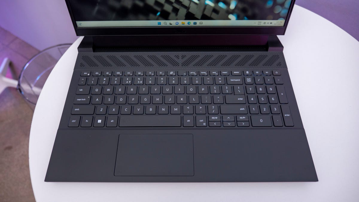 Dell G15 and G16 Gaming Laptops' keyboard on a white table.