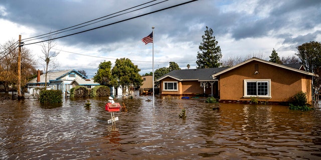 Floodwaters surround homes on Thornton Rd. in Merced, Calif., as storms continue battering the state on Tuesday, Jan. 10, 2023. 