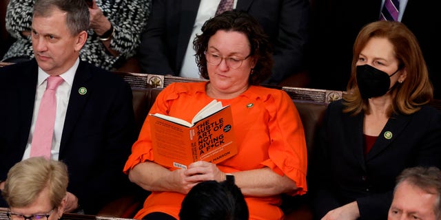 Rep. Katie Porter reads a book in the House Chamber during the fourth day of elections for speaker of the House at the U.S. Capitol on Jan. 6, 2023.