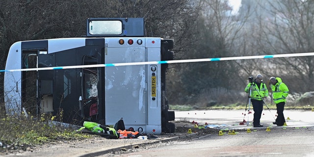 Emergency services work at the scene of a bus crash near Cannington, Britain, January 17, 2023.