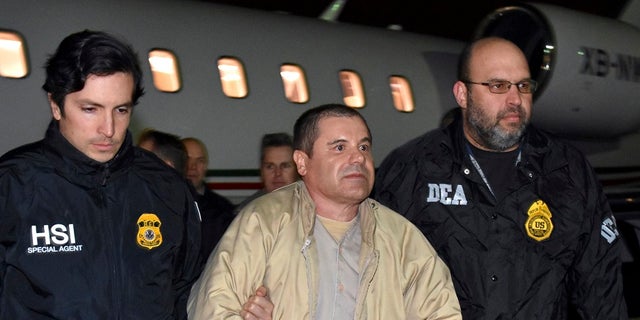 Authorities escort Mexican drug lord Joaquin "El Chapo" Guzman from a plane in Ronkonkoma, N.Y. 