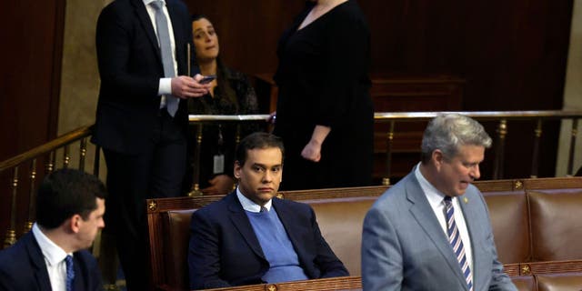 Rep.-elect George Santos sits by himself in the House chamber on the first day of the House speaker race.