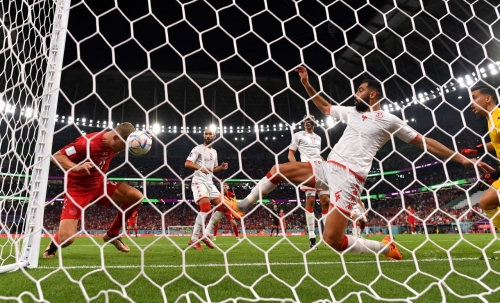 Tunisia's Yassine Meriah stretches to defend a header from Denmark's Andreas Cornelius during their 0-0 draw on November 22.