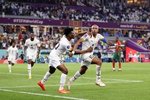 Ghana's Andre Ayew, right, celebrates with Mohammed Kudus after tying the match at 1-1 shortly after Ronaldo's penalty.