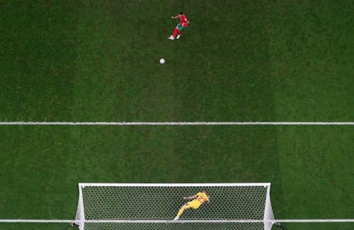 Morocco's Abdelhamid Sabiri scores during the penalty shootout against Spain.