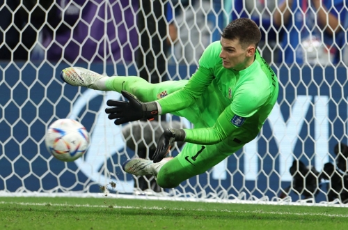 Livaković saves the first penalty in the shootout against Japan.