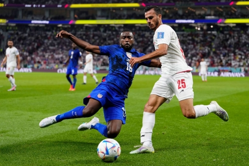 Shaq Moore slides in for a tackle against Iran's Abolfazl Jalali.