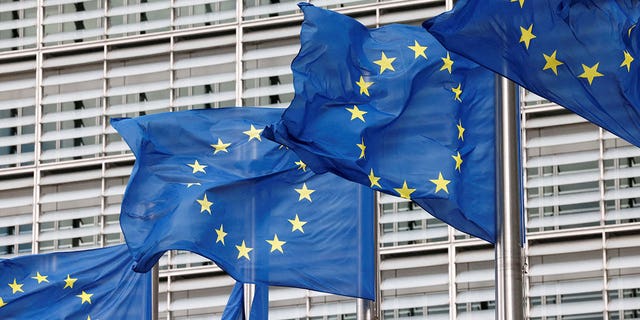 European Union flags flutter outside its headquarters in Brussels, Belgium, on Sept. 28, 2022.