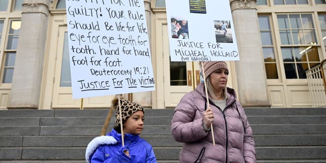 Nine-year-old Lyric Jones and her mother Teran Christian stands outside Wayne Aspinall Courthouse on Jan. 3, 2023 in Grand Junction, Colorado. The two came to the courthouse for the sentencing of Megan Hess and Shirley Koch. Christians grandfather Michael Holland was a victim along with hundreds of other families who used Sunset Mesa Funeral home. 