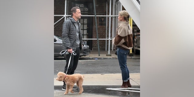 Amy Robach handed off the family dog, Brody to her estranged husband Andrew Shue. The couple appeared tense during the exchange.