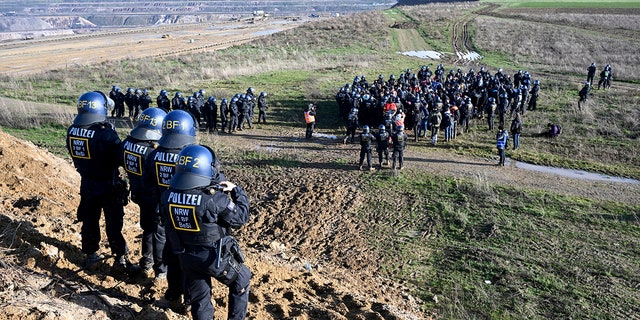 Police officers have surrounded a group of activists and coal opponents on the edge of the Garzweiler II lignite open pit mine during a protest by climate activists following the clearance of Luetzerath, Germany, on Tuesday.