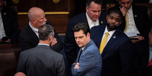 WASHINGTON, DC - JANUARY 04: Rep. Chip Roy, R-TX, Rep. Scott Perry, R-Penn., Rep. Matt Gaetz, R-Fla., and Rep. Byron Donalds, R-Fla., confer with each other on the floor of the House Chamber of the U.S. Capitol Building on Wednesday, Jan. 4, 2023, in Washington, DC. 