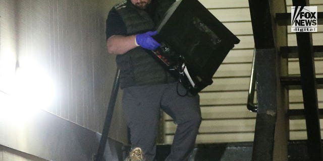 Investigators search Bryan Christopher Kohberger's home in Pullman, Washington after dark on Dec. 30, 2022. Among the items removed was the desktop computer, several boxes of evidence and multiple bags.