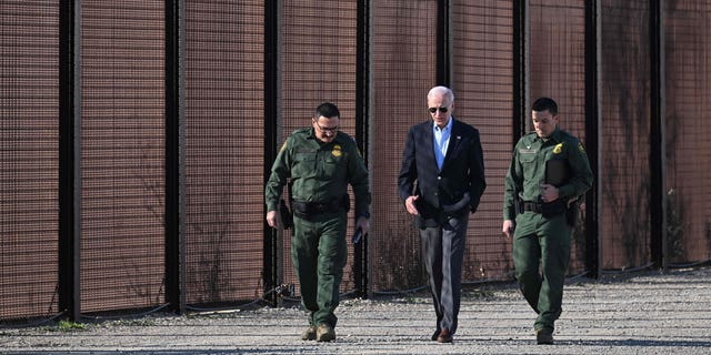 President Biden walks with members of the U.S. Border Patrol along the U.S.-Mexico border fence in El Paso, Texas, on Jan. 8, 2023.